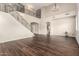 Bright and spacious living area featuring a grand staircase, high ceilings, and sleek flooring at 7220 W Ashby Dr, Peoria, AZ 85383