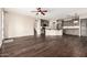 Open-concept living room with dark wood floors flowing into a stylish kitchen with grey cabinetry at 7220 W Ashby Dr, Peoria, AZ 85383