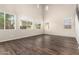 Bright, spacious living room with abundant natural light, high ceilings, and sleek wood-look floors at 7220 W Ashby Dr, Peoria, AZ 85383