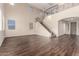 Expansive open-concept living area with tall ceilings, a staircase, and sleek wood-look floors at 7220 W Ashby Dr, Peoria, AZ 85383