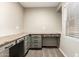 The home office features an L-shaped built-in desk and grey cabinets, with a large window and neutral walls at 7220 W Ashby Dr, Peoria, AZ 85383