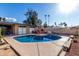 Backyard pool view, which includes an outdoor grill and patio seating, ideal for entertaining or relaxation at 7604 N 46Th Ave, Glendale, AZ 85301