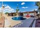 Beautiful backyard pool with an outdoor dining area set against a blue sky backdrop and lush foliage at 7604 N 46Th Ave, Glendale, AZ 85301
