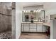 Bathroom features a large vanity, seperate makeup vanity and a stone shower at 7604 N 46Th Ave, Glendale, AZ 85301