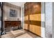 Elegant foyer features a unique display shelf with striped walls and wood-look tile flooring at 7604 N 46Th Ave, Glendale, AZ 85301