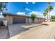 Charming home featuring a spacious driveway and a gray garage door at 7604 N 46Th Ave, Glendale, AZ 85301