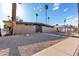 Spacious front yard with desert landscaping and mid-century modern home with a walkway leading to the front entrance at 7604 N 46Th Ave, Glendale, AZ 85301