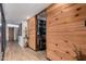 Hallway features neutral walls and wood-look tile, leading to a room with colorful decor and furniture at 7604 N 46Th Ave, Glendale, AZ 85301