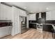 Kitchen features stainless steel appliances and contrasting black and white cabinetry at 7604 N 46Th Ave, Glendale, AZ 85301