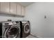 Efficient laundry room equipped with modern, front-loading washer and dryer units at 7604 N 46Th Ave, Glendale, AZ 85301