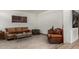 Comfortable living room featuring leather seating, tile floors, and stylish decor at 7604 N 46Th Ave, Glendale, AZ 85301