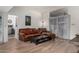 Living room featuring comfortable leather seating and access to the kitchen at 7604 N 46Th Ave, Glendale, AZ 85301