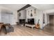 Cozy living room with fireplace, guitar display, and wood-look tile floors at 7604 N 46Th Ave, Glendale, AZ 85301