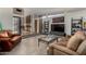 Cozy living room with comfortable leather couches, tile floors, and a view of the glass enclosed atrium at 7604 N 46Th Ave, Glendale, AZ 85301