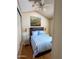 Cozy bedroom with a bed dressed in blue and white striped linens and a decorative painting at 7750 E Broadway Rd # 604, Mesa, AZ 85208