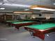 Billiard room with multiple pool tables, lighting, and chairs at 7750 E Broadway Rd # 604, Mesa, AZ 85208