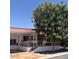Charming single-story home with a covered front porch, mature trees, and red and white accents at 7750 E Broadway Rd # 604, Mesa, AZ 85208
