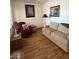 Cozy living area features laminate floors, a sofa, recliner, and two decorative lamps at 7750 E Broadway Rd # 604, Mesa, AZ 85208
