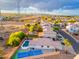 Aerial view of a residential area featuring houses with swimming pools and tennis courts at 7838 N 110 Ln, Glendale, AZ 85307