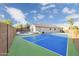 Backyard oasis featuring a tennis court and a refreshing pool with a spacious lounging area at 7838 N 110 Ln, Glendale, AZ 85307