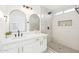 Modern bathroom featuring double vanity and walk-in shower with tiled walls and floors at 7838 N 110 Ln, Glendale, AZ 85307