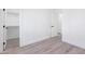 Neutral-toned bedroom featuring a large closet and modern flooring at 7838 N 110 Ln, Glendale, AZ 85307