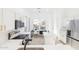 Bright modern kitchen featuring white cabinets, quartz countertops, stainless steel appliances, and an adjacent dining area at 7838 N 110 Ln, Glendale, AZ 85307