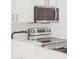 Modern kitchen showcasing stainless steel appliances and sleek countertops at 7838 N 110 Ln, Glendale, AZ 85307