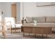 Bright living room featuring modern furniture, including a beige sofa and wood coffee table with stylish decor at 7838 N 110 Ln, Glendale, AZ 85307