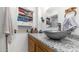 Stylish bathroom featuring a unique vessel sink, granite countertop, and decorative storage at 786 Cinnabar Dr, Apache Junction, AZ 85119