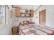 This bedroom features a bed with a floral quilt and built-in cabinets at 786 Cinnabar Dr, Apache Junction, AZ 85119