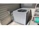 Close-up of an air conditioning unit with a ladder and garden hose next to a mobile home at 786 Cinnabar Dr, Apache Junction, AZ 85119