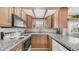 Traditional kitchen with granite counters, wood cabinets, and modern appliances at 786 Cinnabar Dr, Apache Junction, AZ 85119