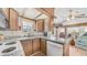 Charming kitchen with wood cabinetry, granite countertops, and a bright window view at 786 Cinnabar Dr, Apache Junction, AZ 85119