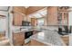 Well-maintained kitchen featuring wood cabinets, granite counters, and updated appliances at 786 Cinnabar Dr, Apache Junction, AZ 85119
