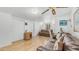 Bright living room with hardwood floors, two sofas, a ceiling fan, and natural light from the window at 786 Cinnabar Dr, Apache Junction, AZ 85119