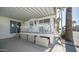 White patio with white railings and cabinets for storage under a white roof and blue sky at 786 Cinnabar Dr, Apache Junction, AZ 85119