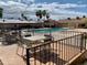 Outdoor tables and seating near a fenced pool and palm trees at 786 Cinnabar Dr, Apache Junction, AZ 85119