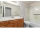 Bathroom featuring a wood vanity cabinet, a shower/tub combo and a large mirror at 10431 E Morning Star Dr, Scottsdale, AZ 85255