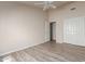 Bright bedroom featuring a ceiling fan, wood floors, and a closet with double doors at 10431 E Morning Star Dr, Scottsdale, AZ 85255