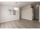 Dining area featuring modern light fixture, wood-look flooring, and an opening to the kitchen at 10431 E Morning Star Dr, Scottsdale, AZ 85255