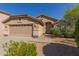 Charming single-story home with a well-maintained front yard and a two-car garage in a sunny setting at 10431 E Morning Star Dr, Scottsdale, AZ 85255