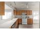 Well-lit kitchen featuring light wood cabinets, white appliances, and neutral countertops and flooring at 10431 E Morning Star Dr, Scottsdale, AZ 85255