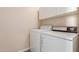 Laundry room features white washer, dryer, and a white cabinet hanging above at 10431 E Morning Star Dr, Scottsdale, AZ 85255