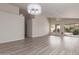 Bright living room with modern lighting, neutral walls, updated flooring, and vaulted ceiling at 10431 E Morning Star Dr, Scottsdale, AZ 85255