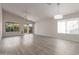 Spacious living room featuring new wood-look flooring, large windows, and sliding glass doors at 10431 E Morning Star Dr, Scottsdale, AZ 85255