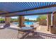 Inviting pool area featuring shaded seating under a pergola, perfect for relaxing poolside at 10431 E Morning Star Dr, Scottsdale, AZ 85255