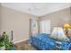 Well lit bedroom with tile floors and a comfortable bed at 1081 W Stephanie Ln, San Tan Valley, AZ 85143