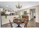Cozy dining room with wooden table set, chandelier, and view to the kitchen at 1081 W Stephanie Ln, San Tan Valley, AZ 85143