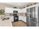 Bright kitchen with white cabinets, stainless steel refrigerator, and stylish countertops at 1081 W Stephanie Ln, San Tan Valley, AZ 85143